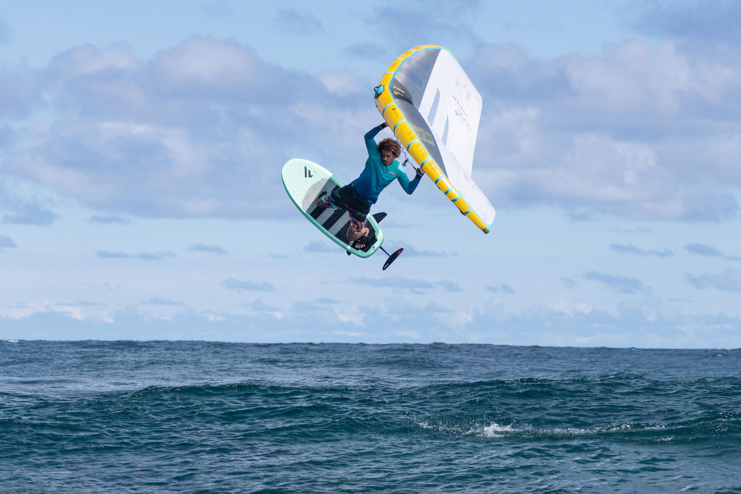 rider jumping with a wingfoil gear